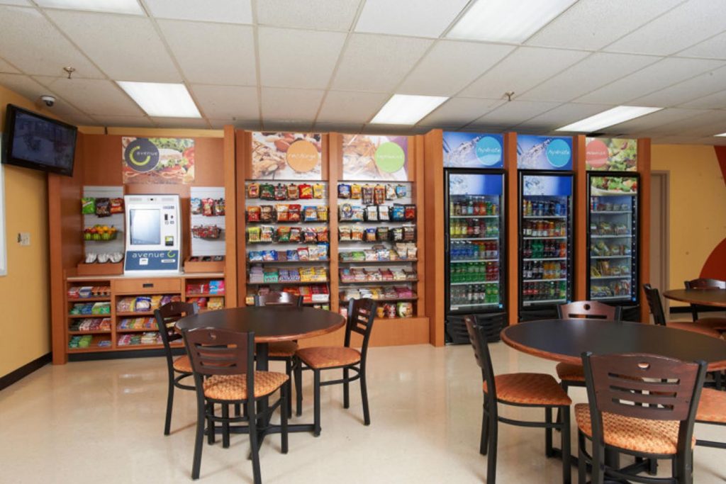 a full micro market with tables and chairs in a break room