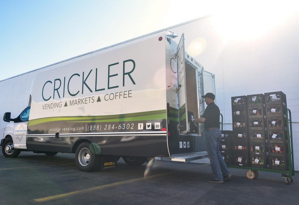 Crickler Vending delivery driver loading his delivery truck with supplies for Micro Markets, Office Coffee Service, and Vending Machines