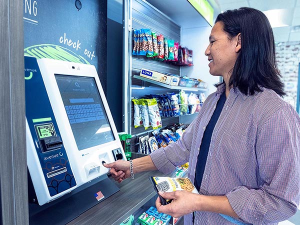 a man checks out a micro market kiosk using his fingerprint
